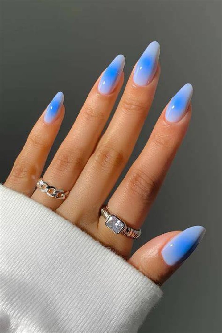 Aura nails with soft blended gradient in lilac, peach, and pink tones