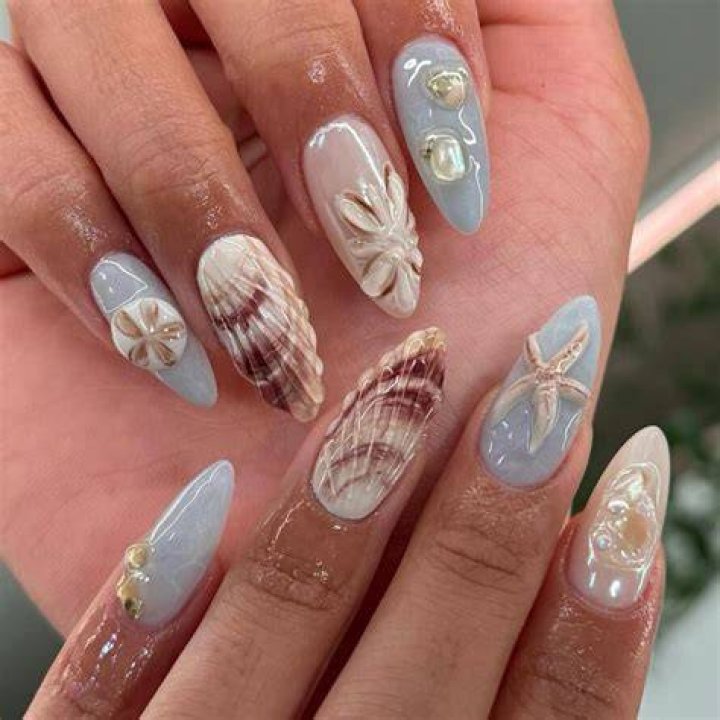 Coastal grandmother aesthetic nails in cream, sandy beige, and soft seafoam with shell details