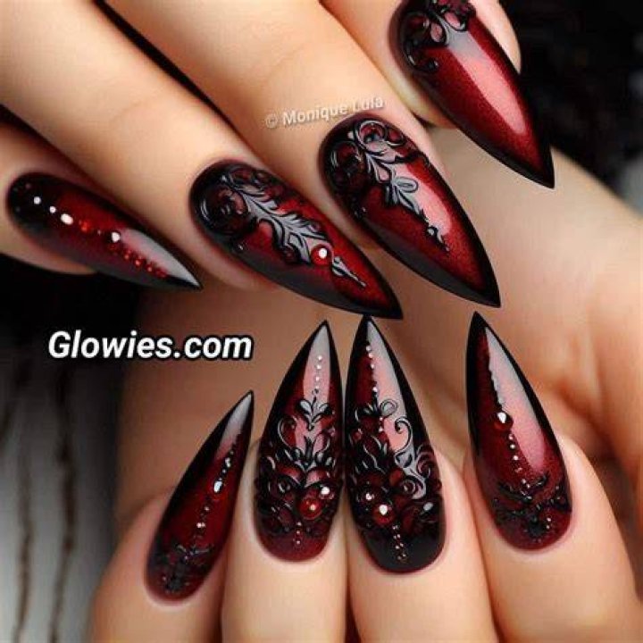 Dark moody gothic nail art in deep burgundy, black, and plum tones