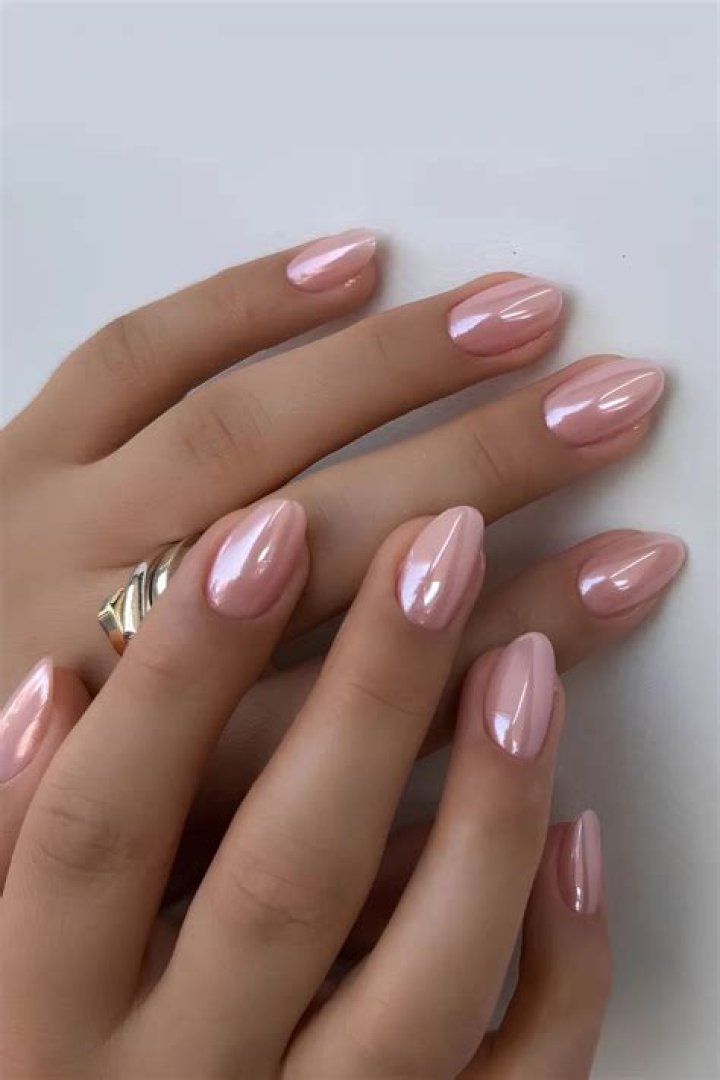Glazed chrome nails with a glass-like mirror finish in soft pearl tones