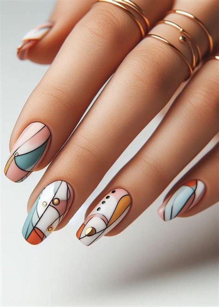 Graphic abstract line art nail designs with bold black lines on cream and colored backgrounds