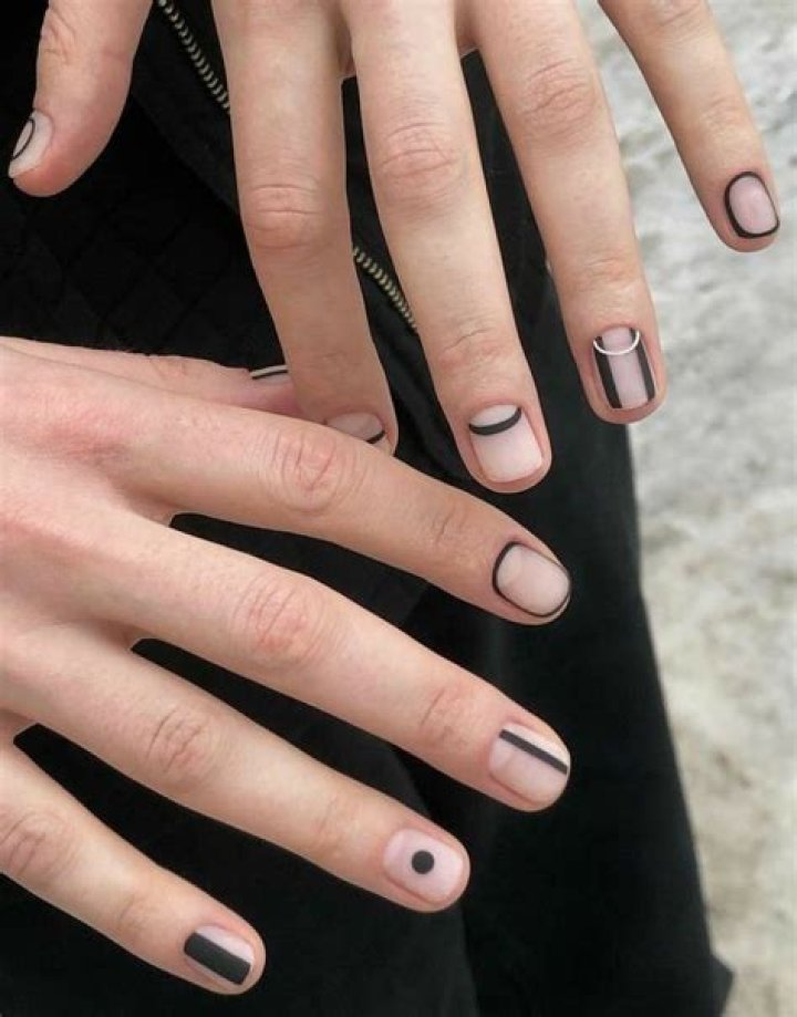 Minimalist negative space nail art with clean geometric lines and bare nail showing